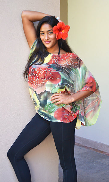 The Hawaii poncho is beautifully painted with field daisies and red Hawaiian flowers. This silk chiffon poncho is perfect to wear to a summer party or traveling in summer ! It drapes well and can also be worn as a scarf. Wear it with a camisole on a summer day and feel cool yet be covered from the sun. Wear it in deep winter over a sweater or as a scarf !