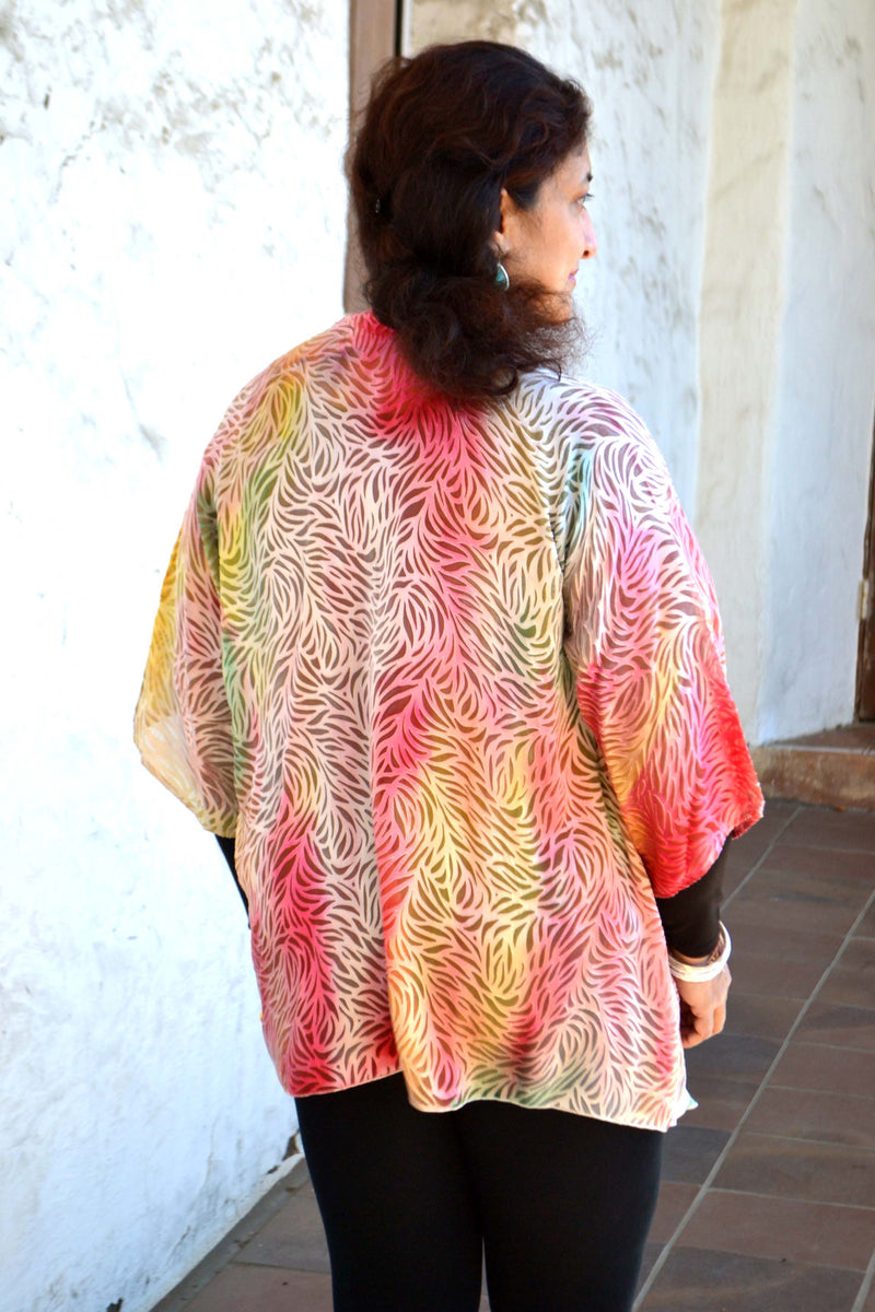 This peach orange hand painted devore kimono jacket is available in sizes S-L. It can be hand washed or dry cleaned. These jackets have a scarf like edge and can be tied at the waist. You can wear it with solid sweaters, camisoles. dresses. A matching Poshaq silk camisole can be made separately once ordered.