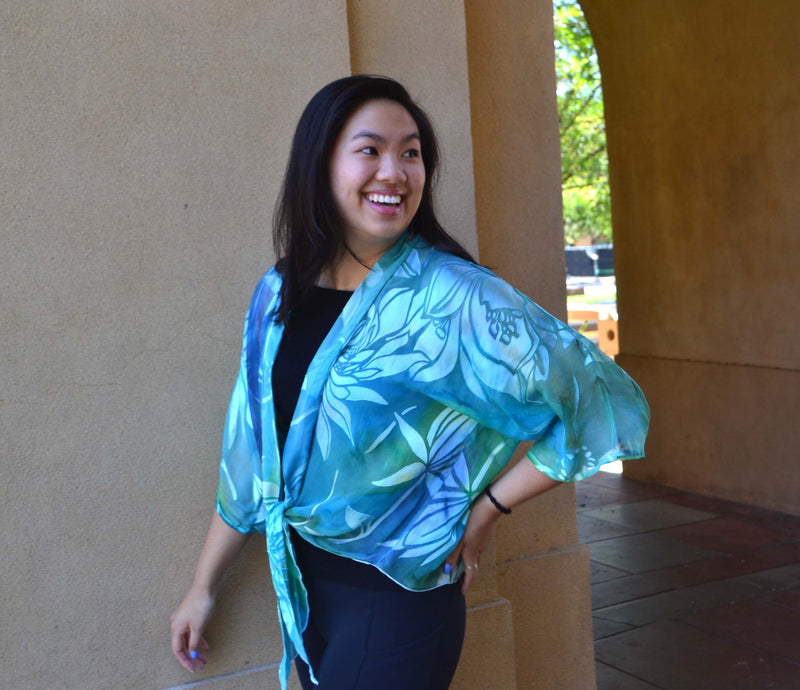 This turquoise blue hand painted devore kimono jacket is available in sizes S-L. It can be hand washed or dry cleaned. These jackets have a scarf like edge and can be tied at the waist. You can wear  it with solid sweaters, camisoles. dresses. A matching silk camisole can be made separately once ordered.