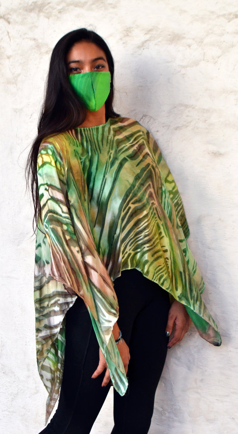 The green wave devore poncho can be worn as a blouse or a scarf. 